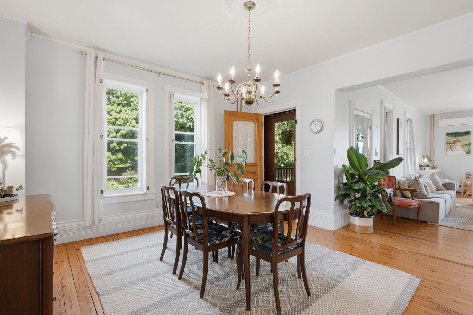 Dining room with hardwood floors, chandelier and tall windows