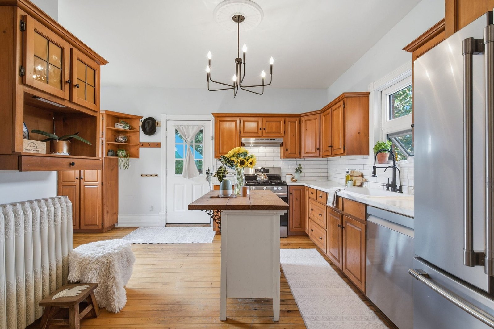 Kitchen with wood cabinetry, island and stainless appliances
