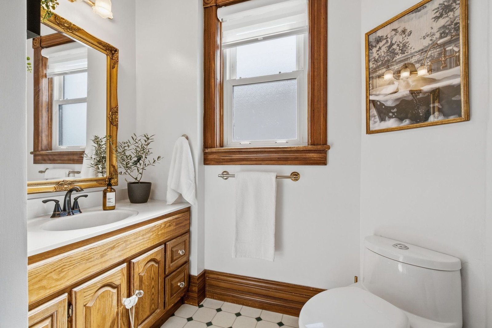 Second bathroom with wood vanity and tile floor