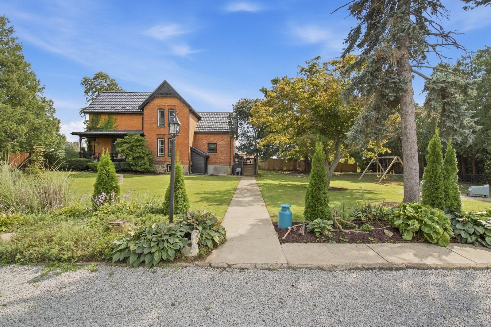 Garden path with mature trees and the house beyond