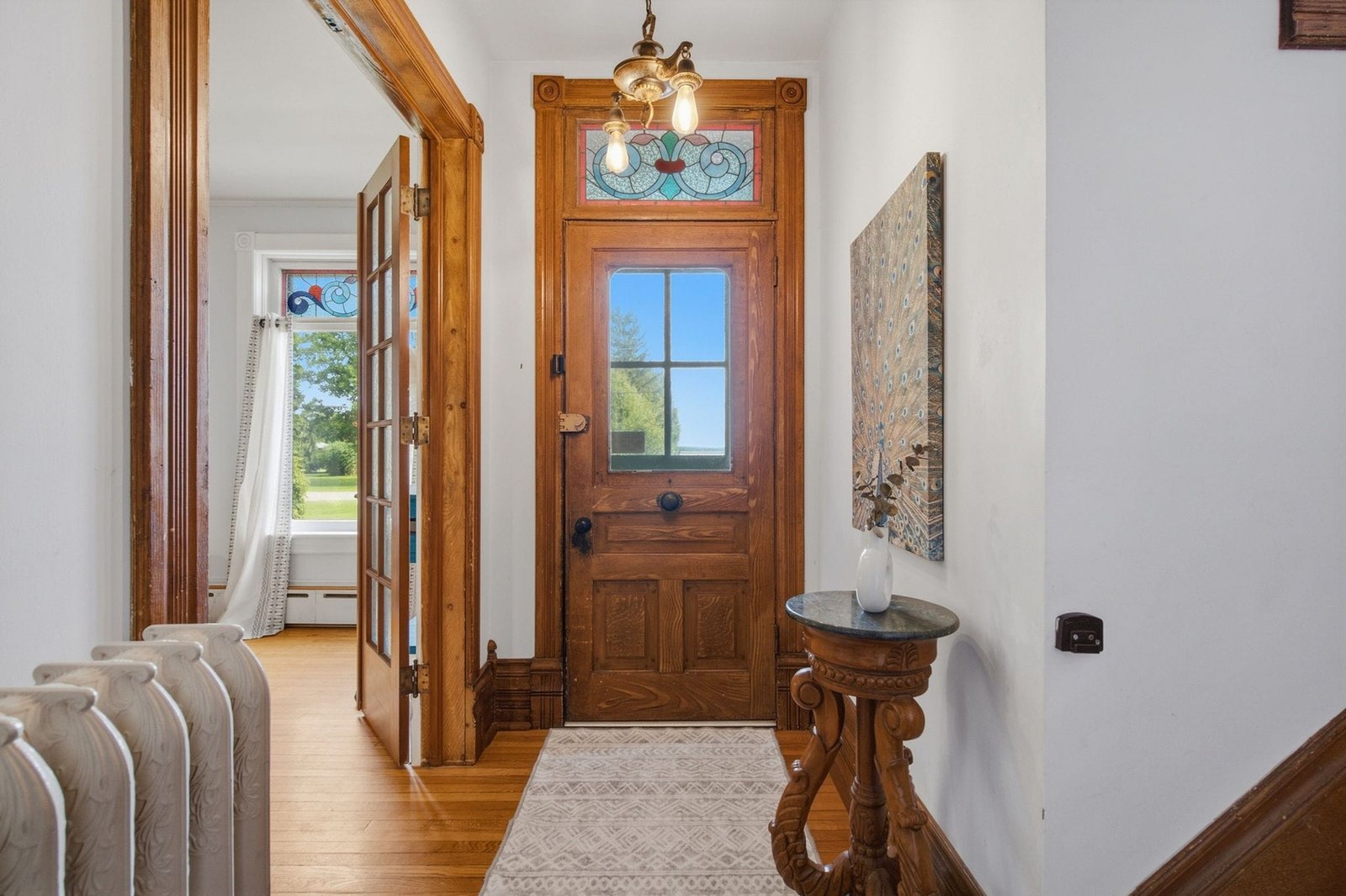 Front entry with original wood door and stained glass transom