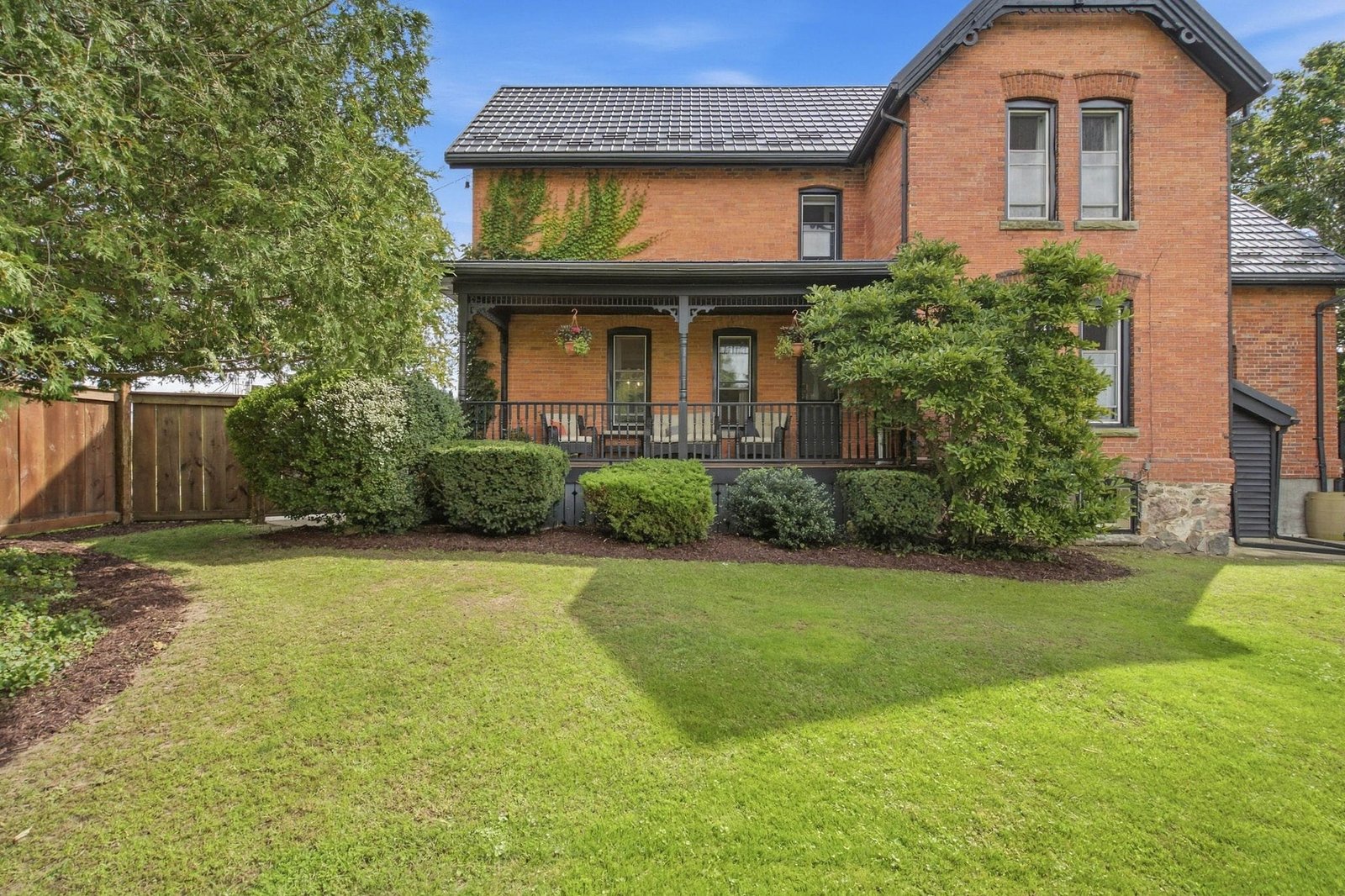 Rear and side view of 136 King Street South showing the terracotta brick and the lawn