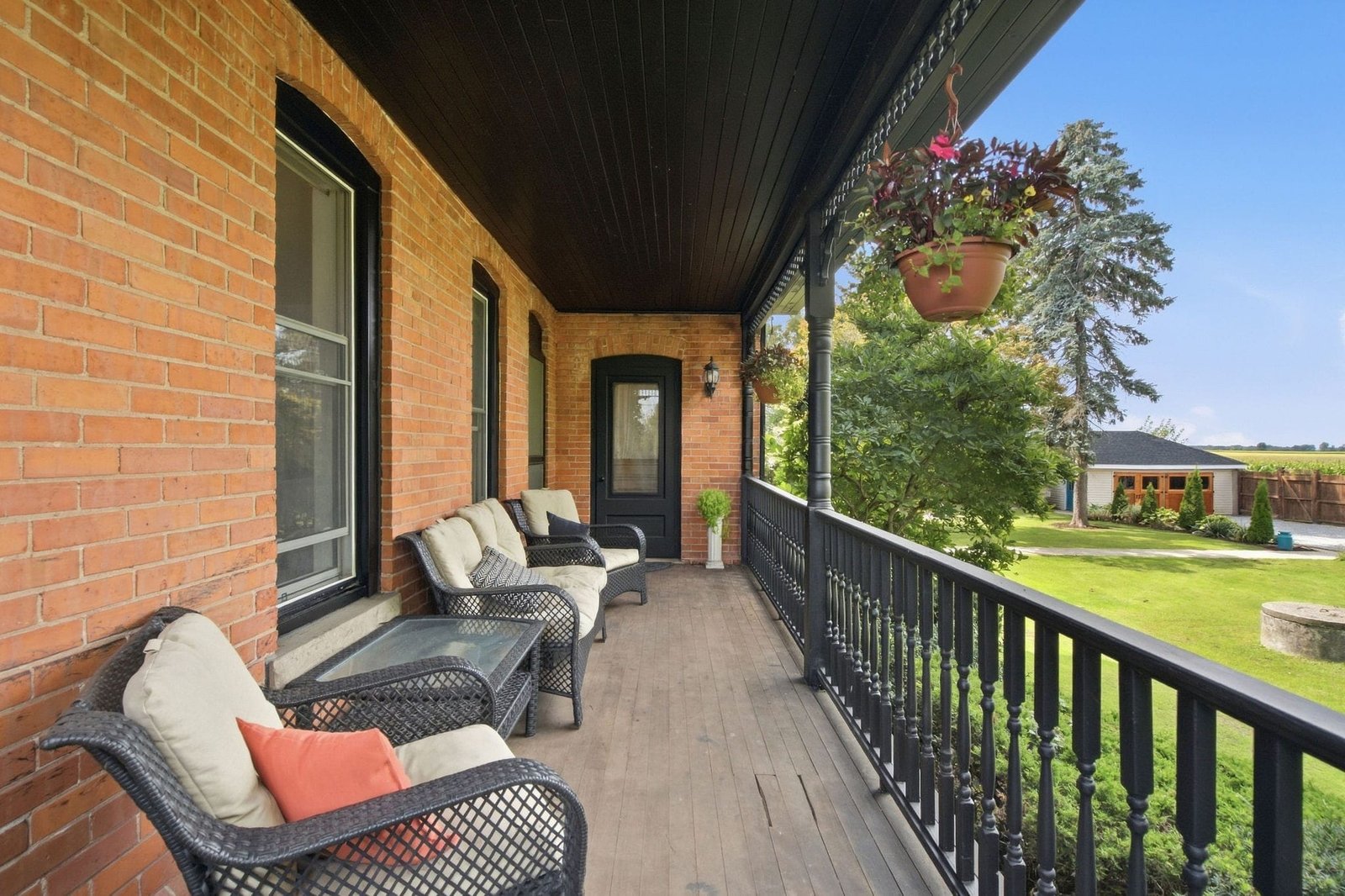 Covered porch with seating and view over the yard